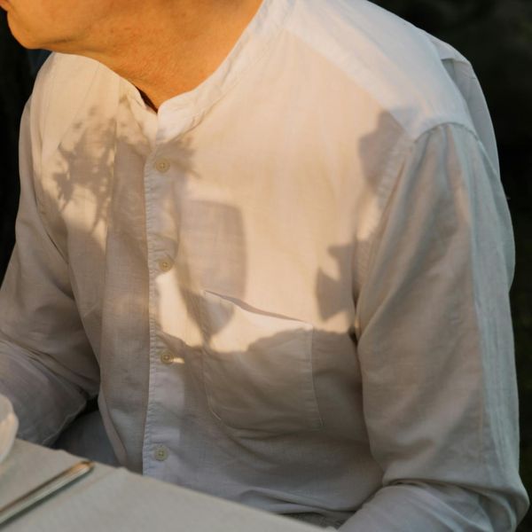 Person meditating peacefully in a natural outdoor setting.